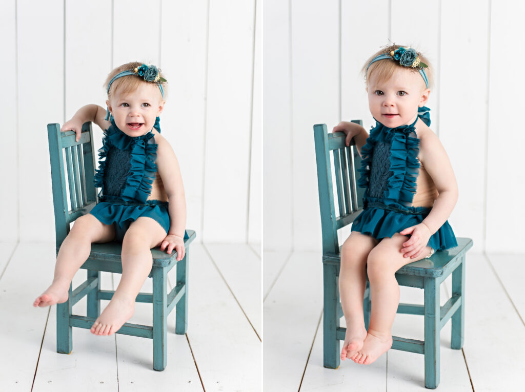 Baby girl sitter session with teal romper and garden tieback sitting on a teal chair with a white wood background.