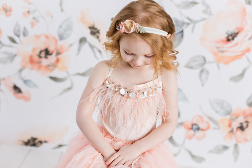 Tutu Du Monde children photography session with peach colored floral background and floral headband. CB Studio Photography