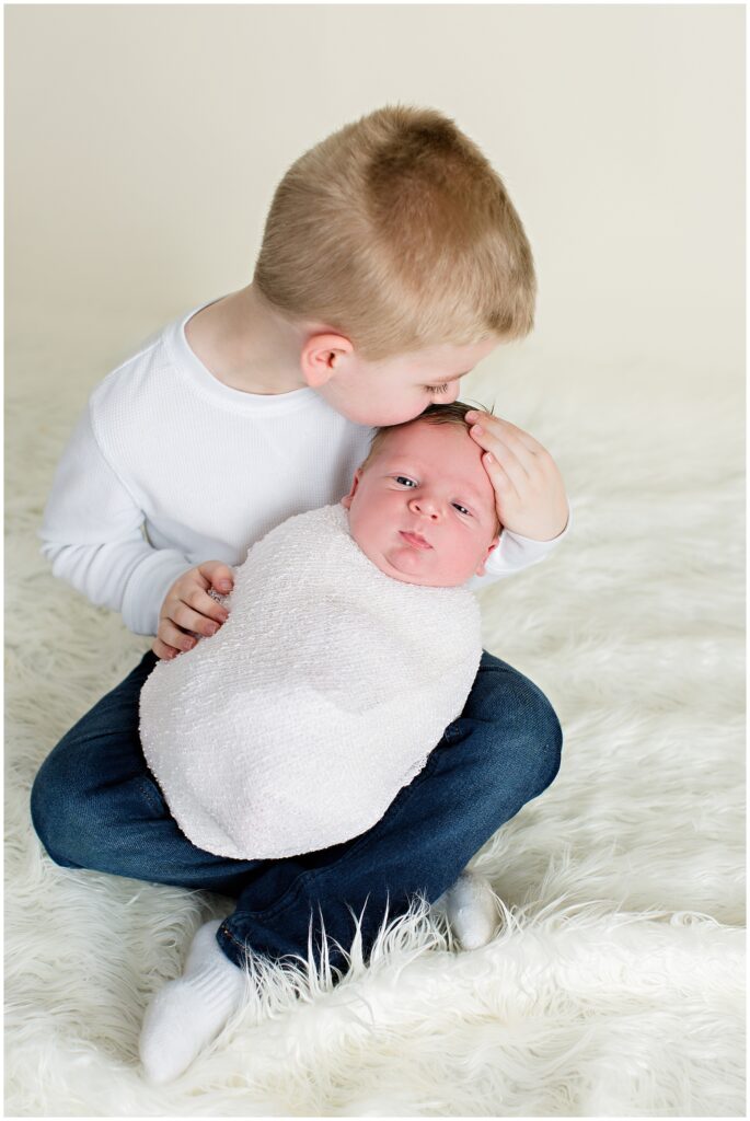 Newborn Wrap Pose with Older Brother | CB Studio, LLC Iowa Photographer | White wrap and cream background