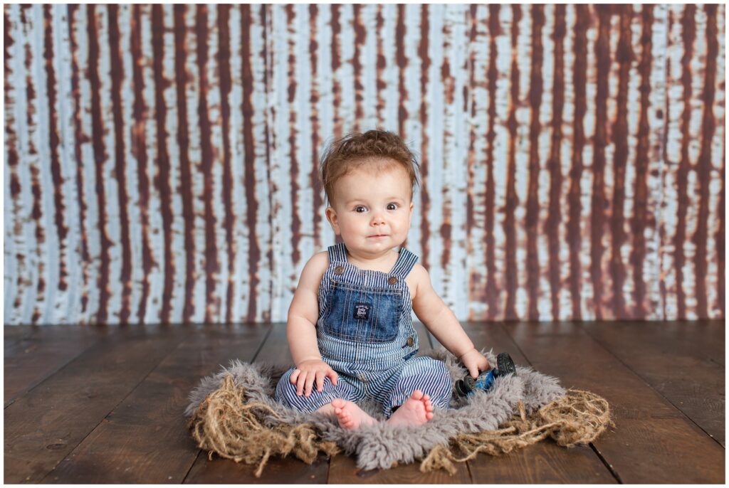 Sitter Session with bib overalls, metal and wood rustic background | Iowa Baby Photographer | CB Studio