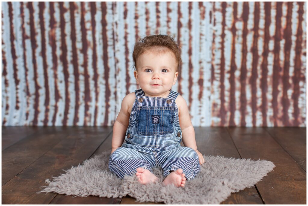 Sitter Session with bib overalls, metal and wood rustic background | Iowa Baby Photographer | CB Studio