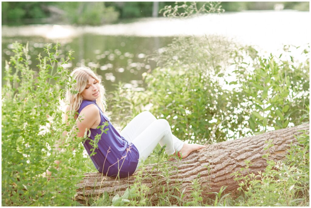 Senior portrait session at a park during golden hour | Senior girl poses by a lake | Iowa Senior Photographer | CB Studio
