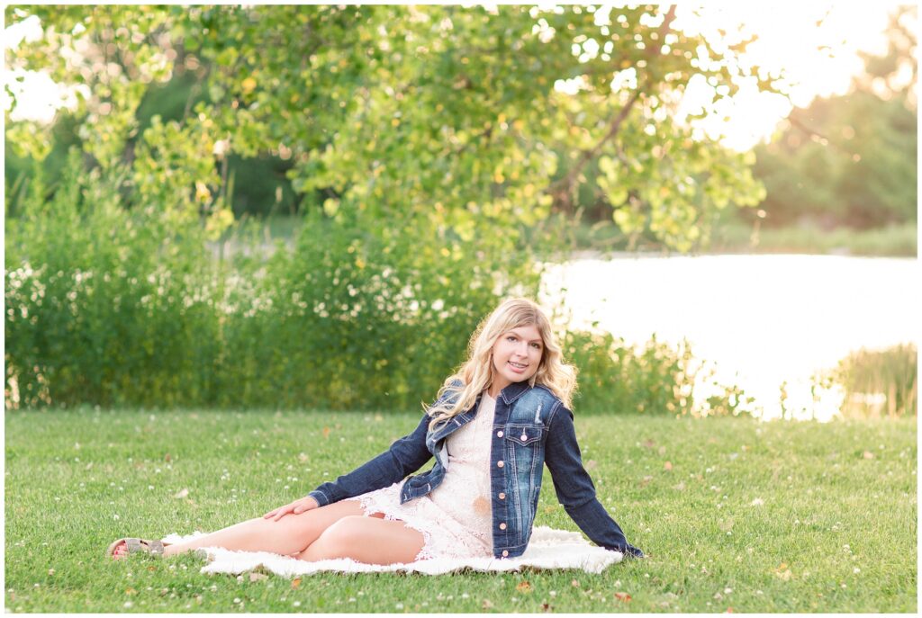 Senior portrait session at a park during golden hour | Senior girl poses by a lake | Iowa Senior Photographer | CB Studio