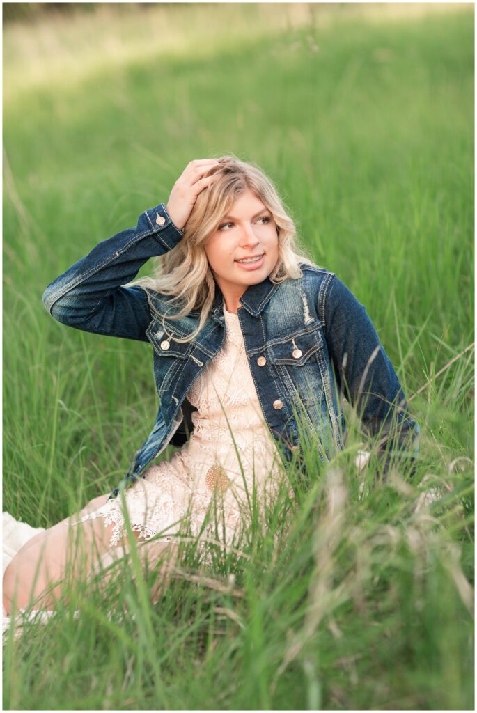 Senior portrait session at a park during golden hour | Senior girl poses in a grassy field | Iowa Senior Photographer | CB Studio