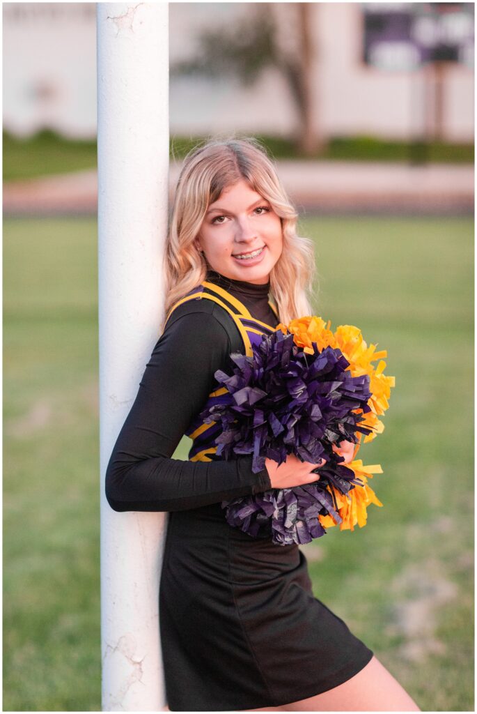 Senior portrait session at a park during golden hour | Senior girl cheerleading poses | Iowa Senior Photographer | CB Studio