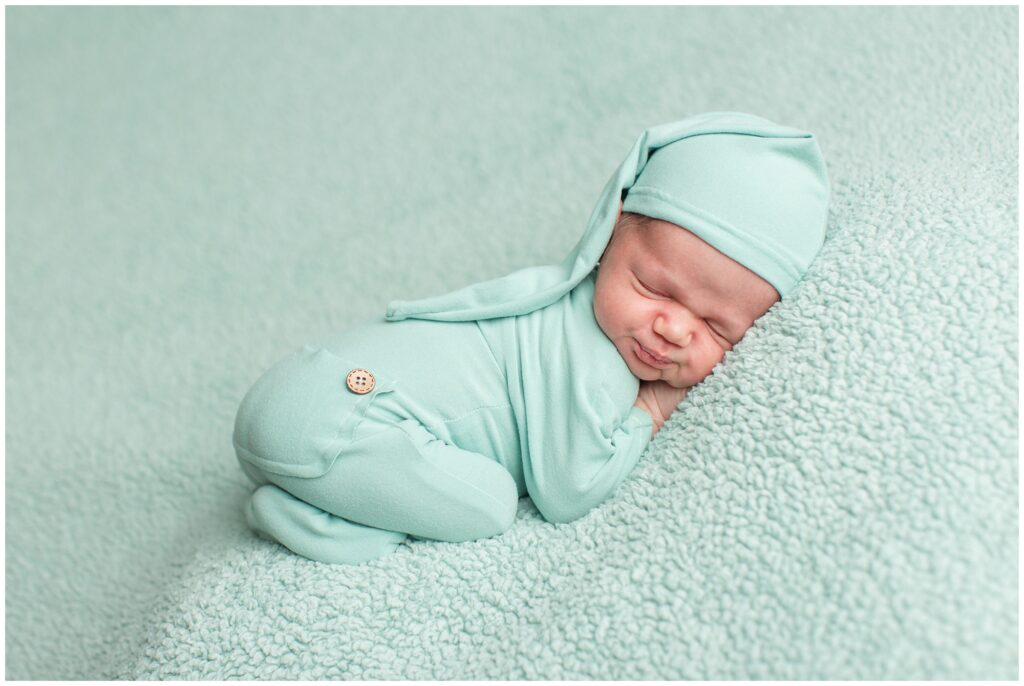 Newborn in mint green romper bean bag pose | Iowa Newborn Photographer | CB Studio
