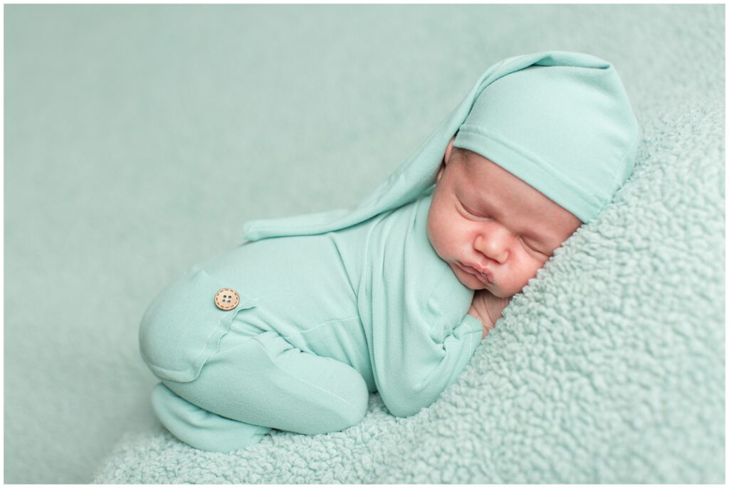Newborn in mint green romper bean bag pose | Iowa Newborn Photographer | CB Studio