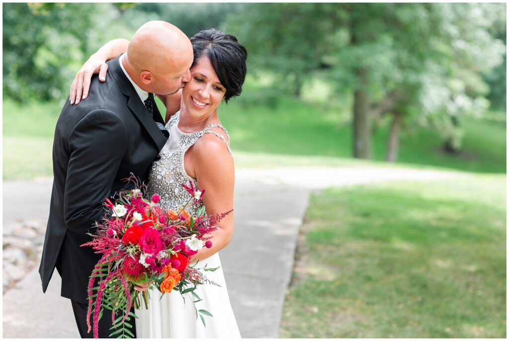 Bride and groom pose on a golf course | Iowa Wedding Photographer | CB Studio