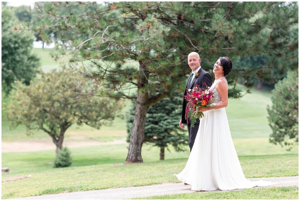 Bride and groom pose on a golf course | Iowa Wedding Photographer | CB Studio
