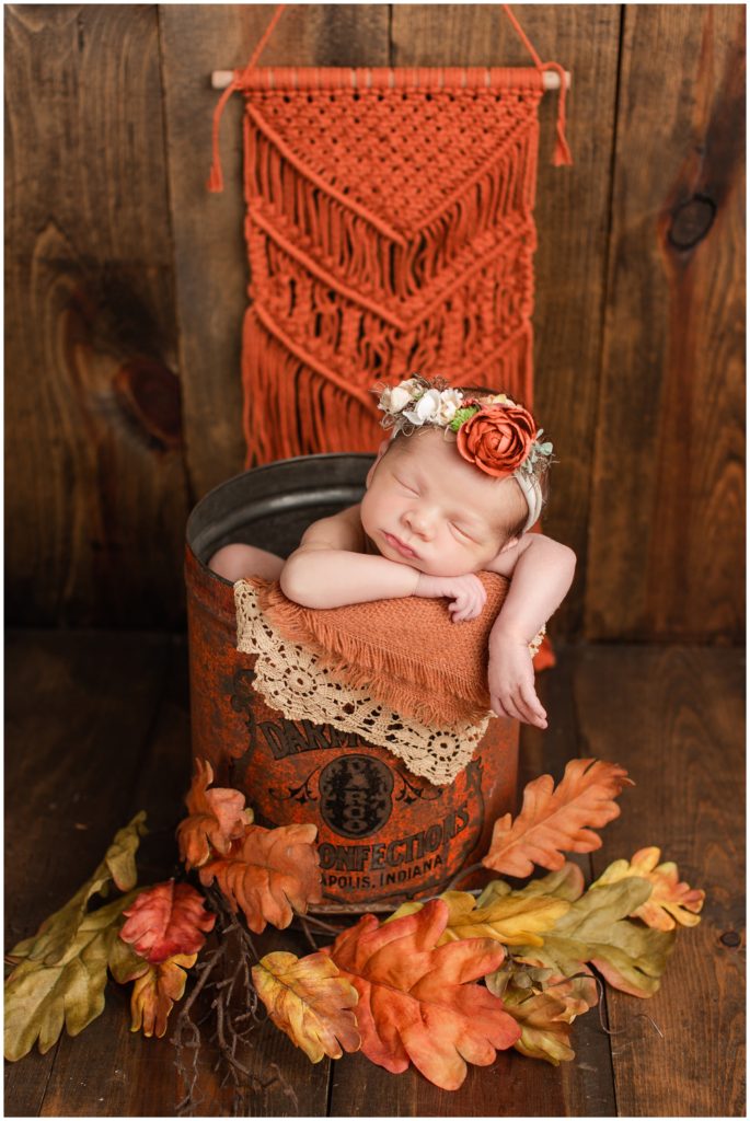 Fall Newborn posed in an orange, rustic bucket with lace, fall leaves, burlap and macrame details | Iowa Newborn Photographer | CB Studio