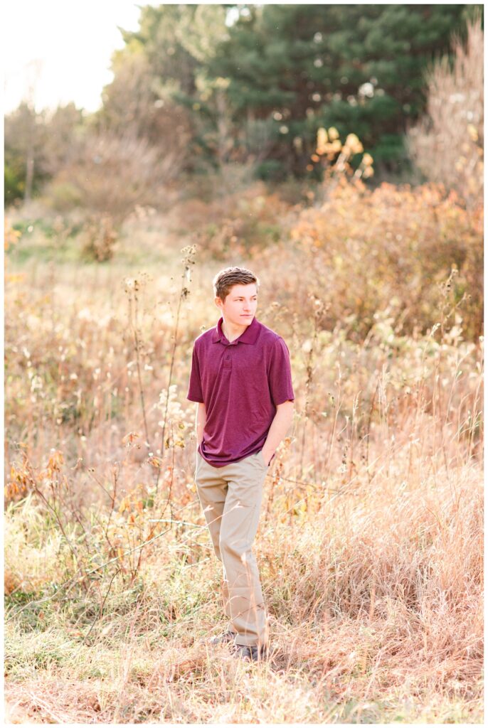 Fall senior boy session standing in a grassy field | Iowa Senior Photographer | CB Studio