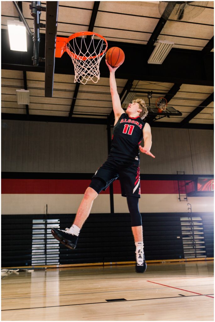 Senior boy shooting a basketball in the Algona High School gym | Iowa Senior Photographer | CB Studio