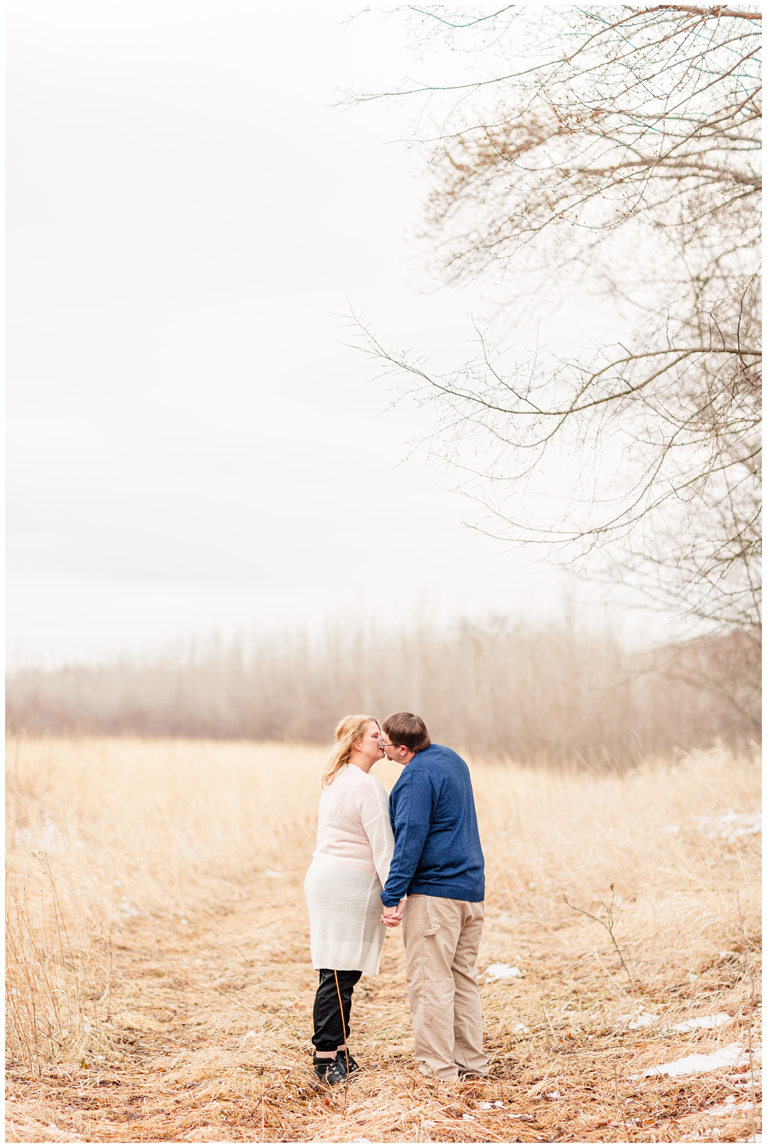 Engagement shoot in a grassy pasture in central Iowa in mid-March