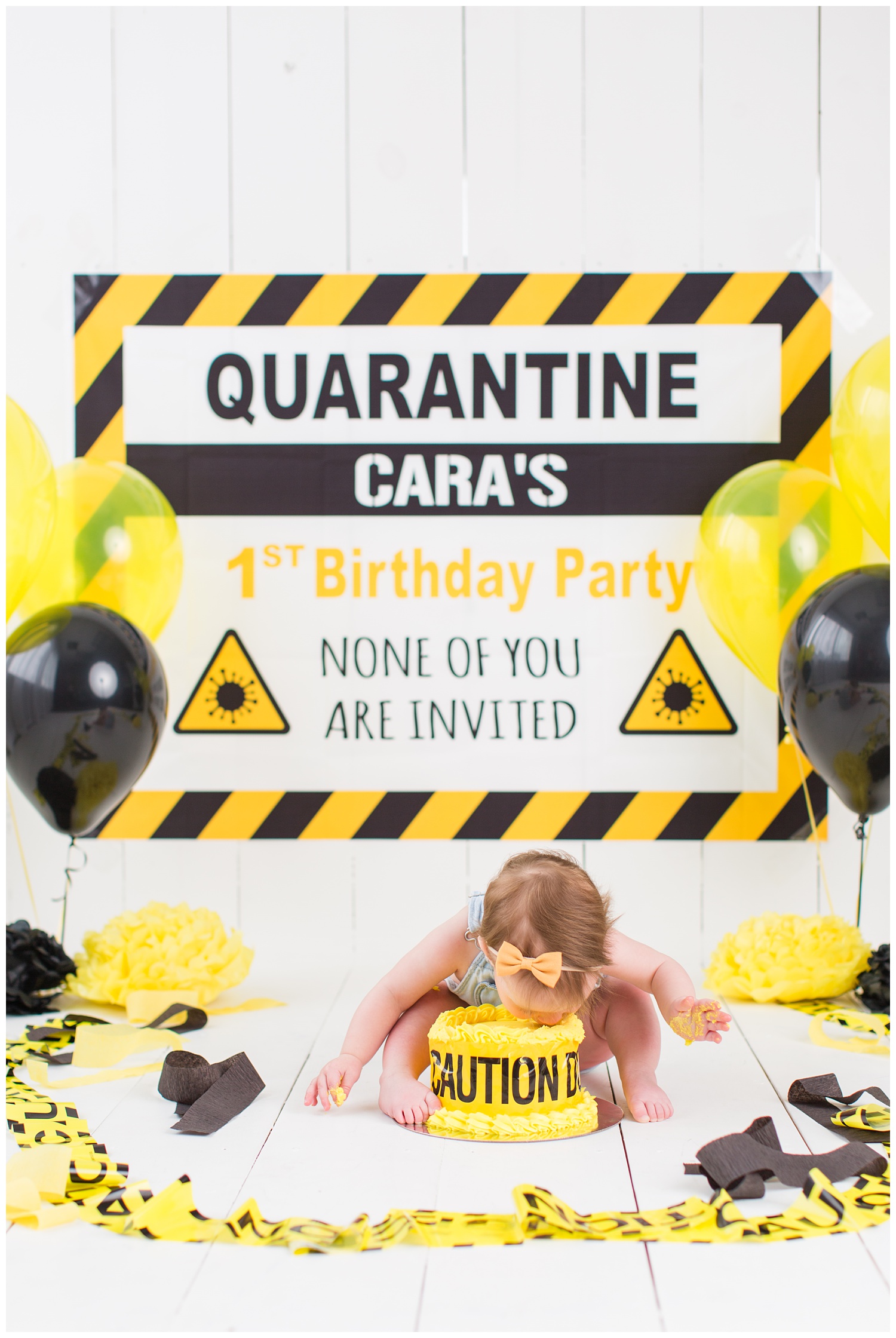 Quarantined themed cake smash complete with caution tape and yellow and black balloons | CB Studio