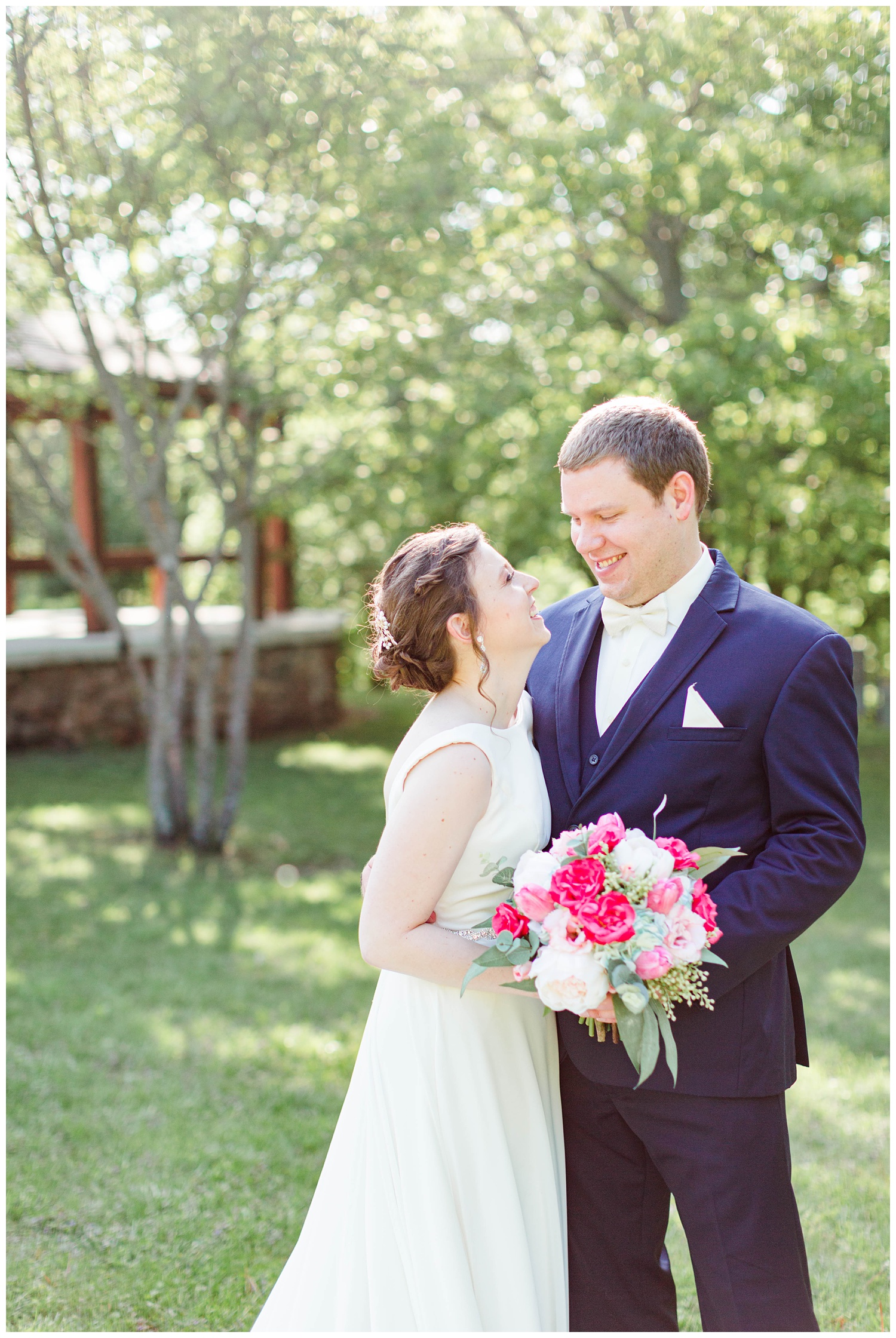 Bride and groom look at each other with a scenic view in Call Park Algona Iowa | CB Studio