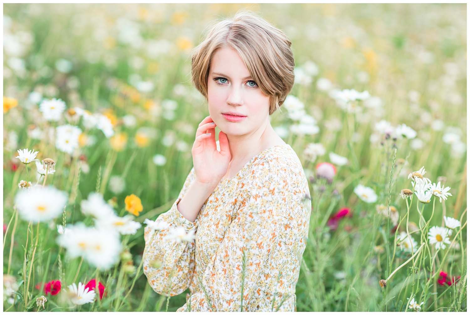 Vintage, film inspired, 70s retro styled senior photoshoot at golden hour in a floral field. | CB Studio