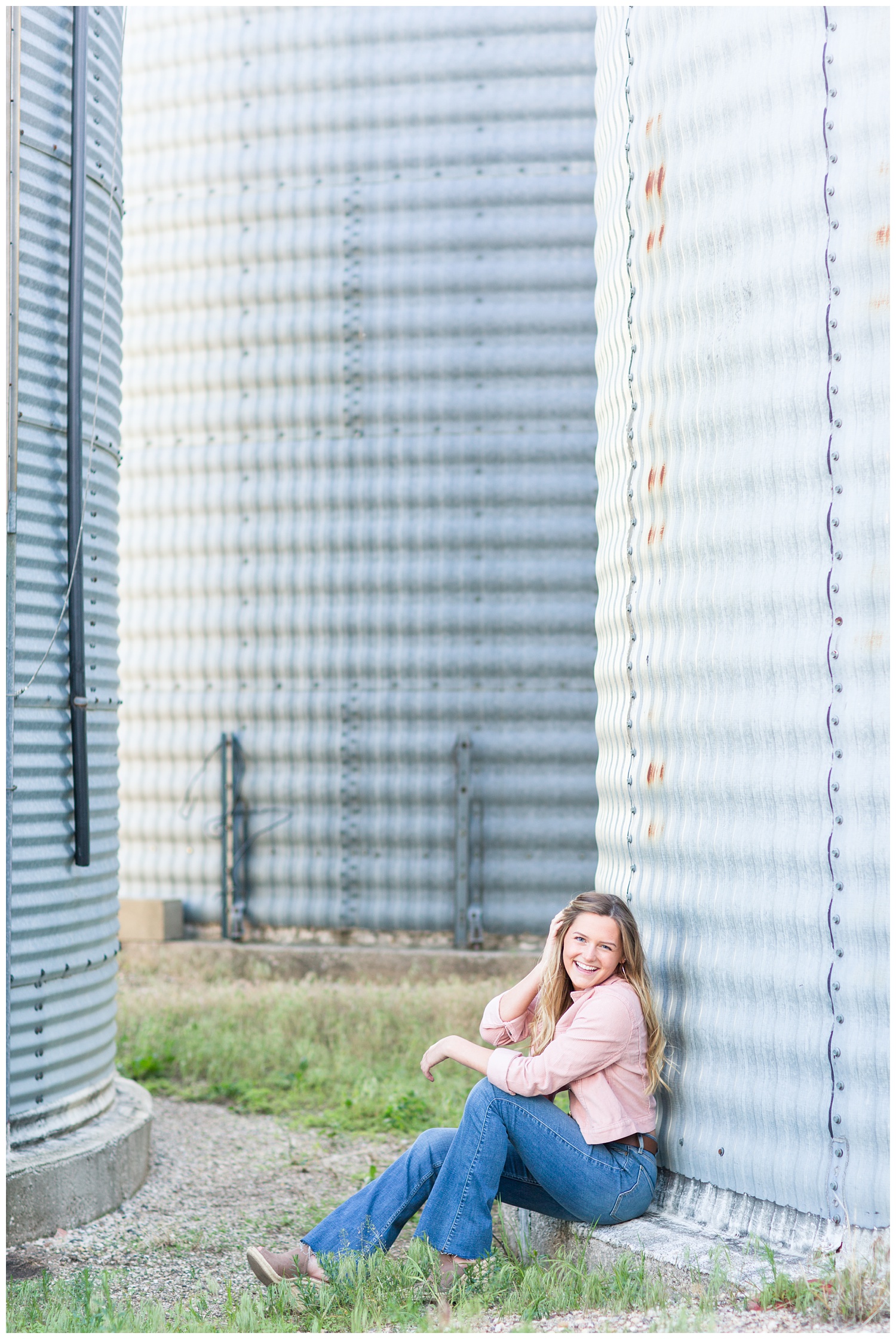 Senior girl sitting next to a grain bin in rural north central Iowa | CB Studio