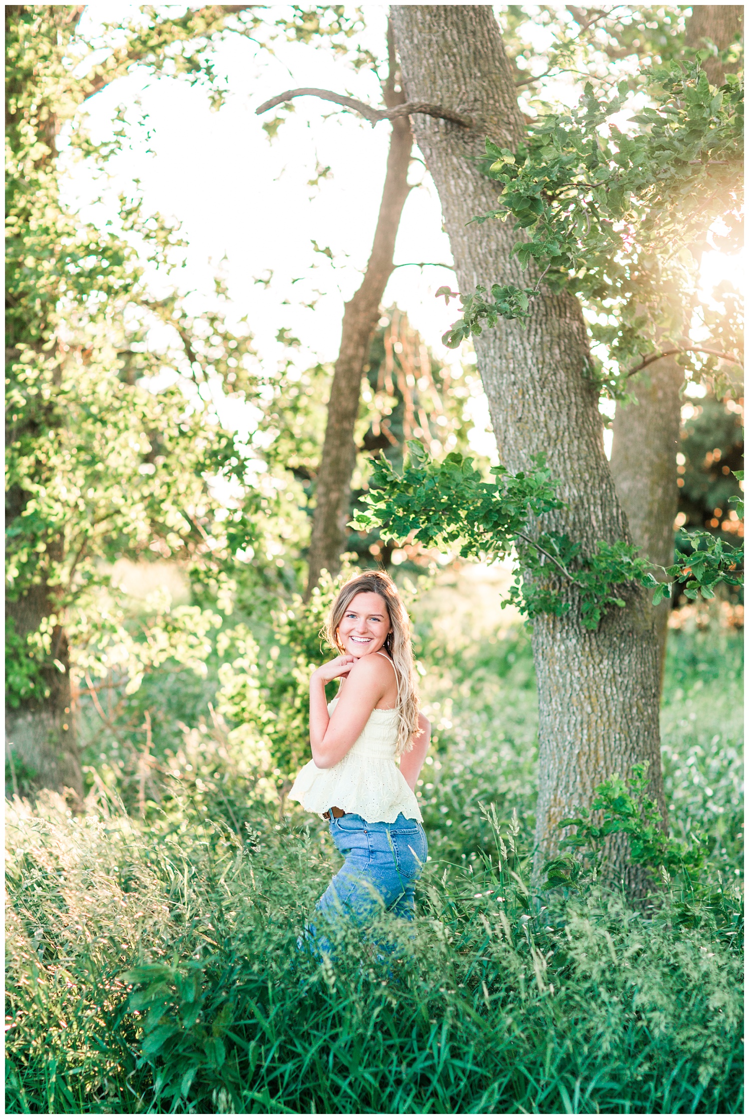 Senior girl posing in a grassy field | CB Studio