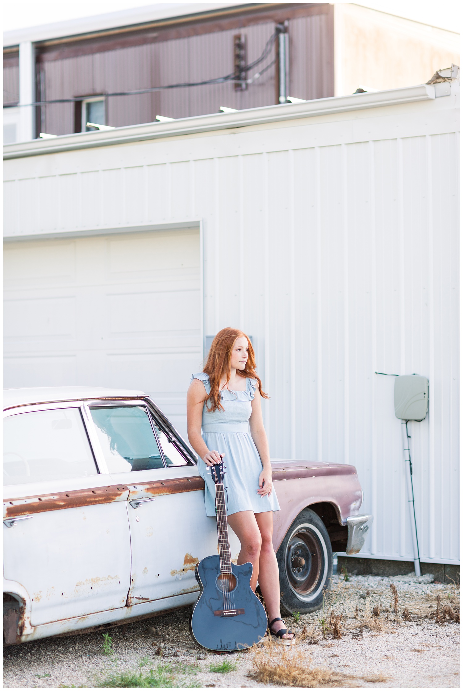 Senior girl leaning against a rustic, vintage car with her guitar in West Bend, Iowa | CB Studio 