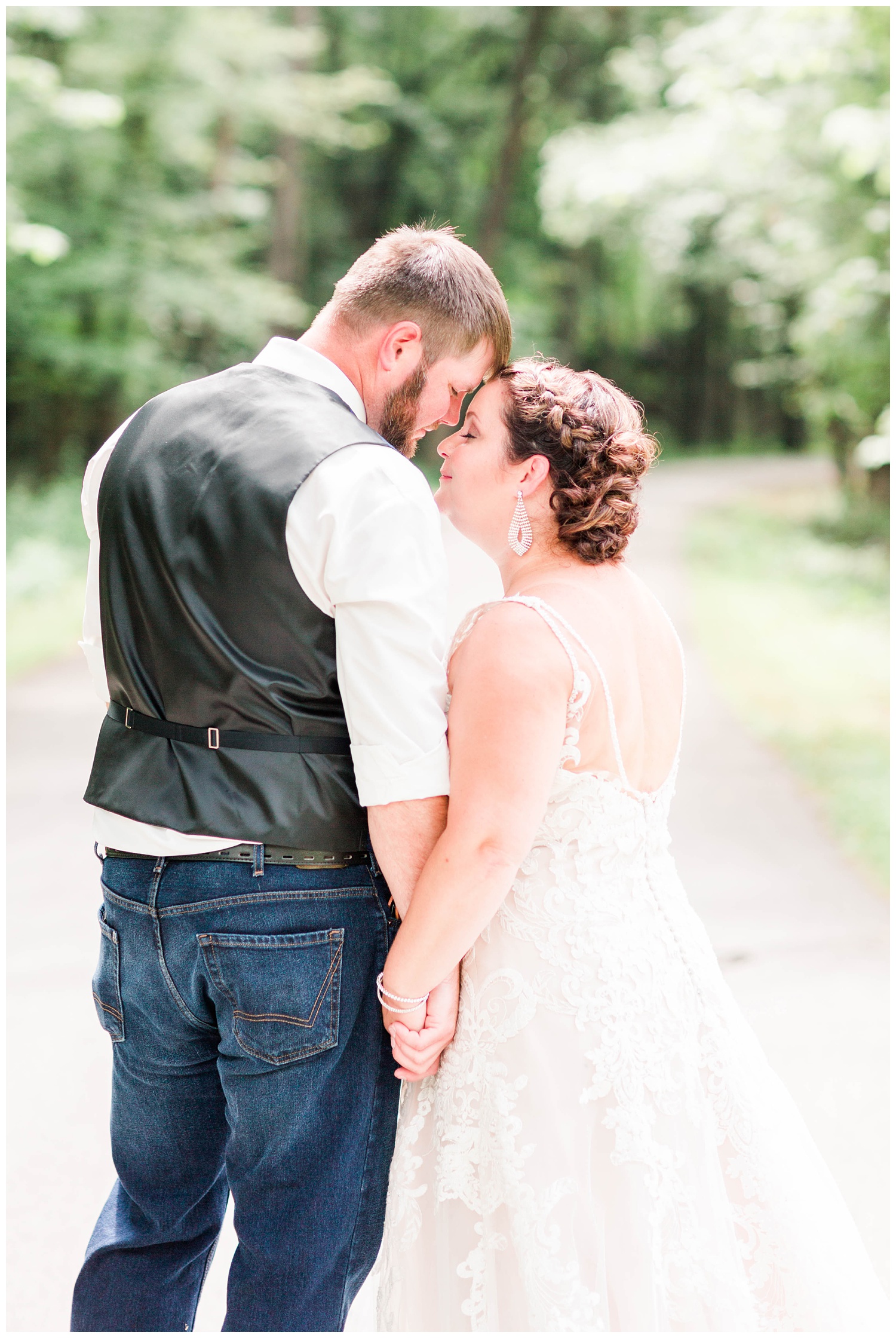 Bride and groom stand intimately close on a pathway in Call Park in Algona, Iowa | CB Studio