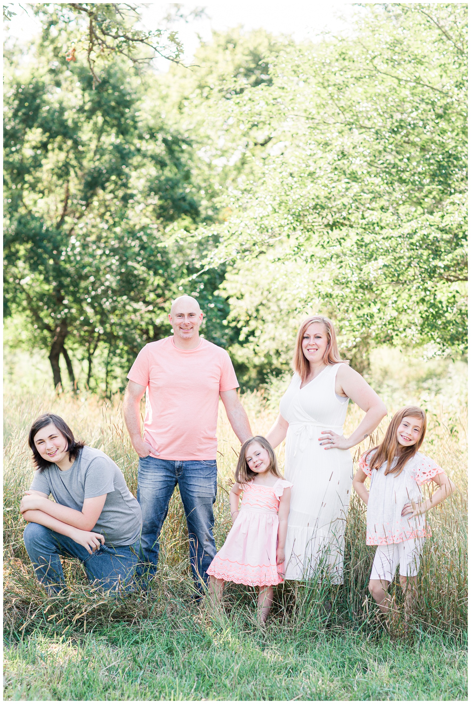 Bright and airy family stand in a grassy field in Iowa | CB Studio