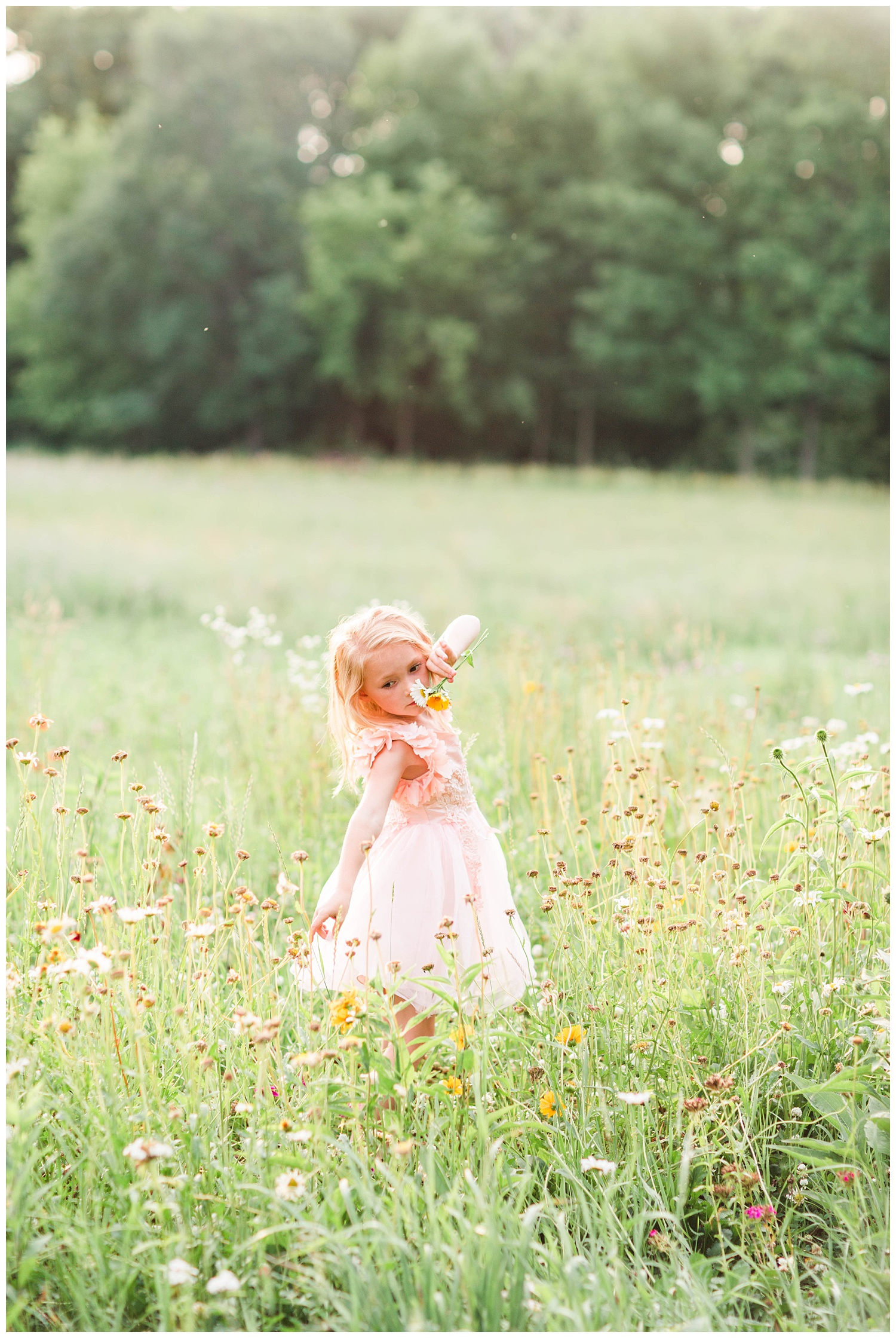 Little Liella dances in a field of wild flowers holding a bouquet wearing tutu du monde couture dress by Trish Scully | CB Studio