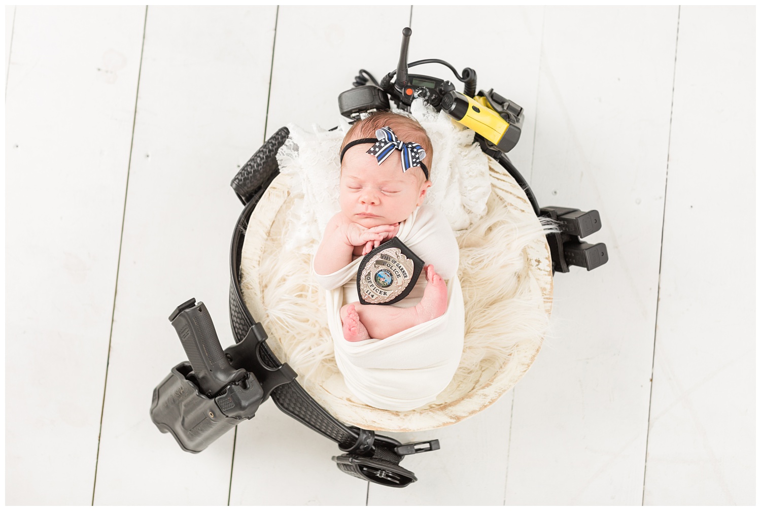 Thin Blue Line police support newborn baby girl wrapped in white supports her daddy who is a police officer in Garner, Iowa | CB Studio