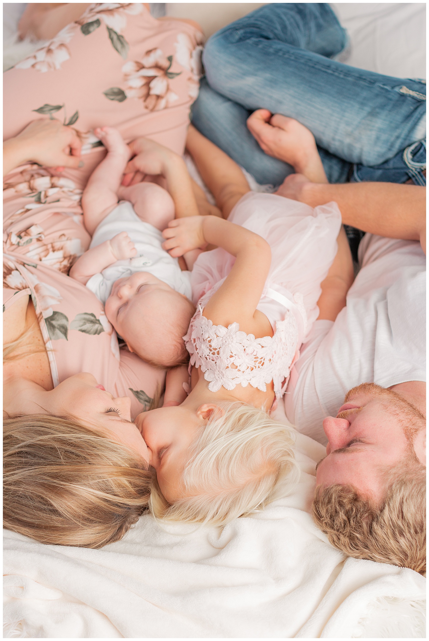 A young family snuggle together during a snuggle photography session | CB Studio