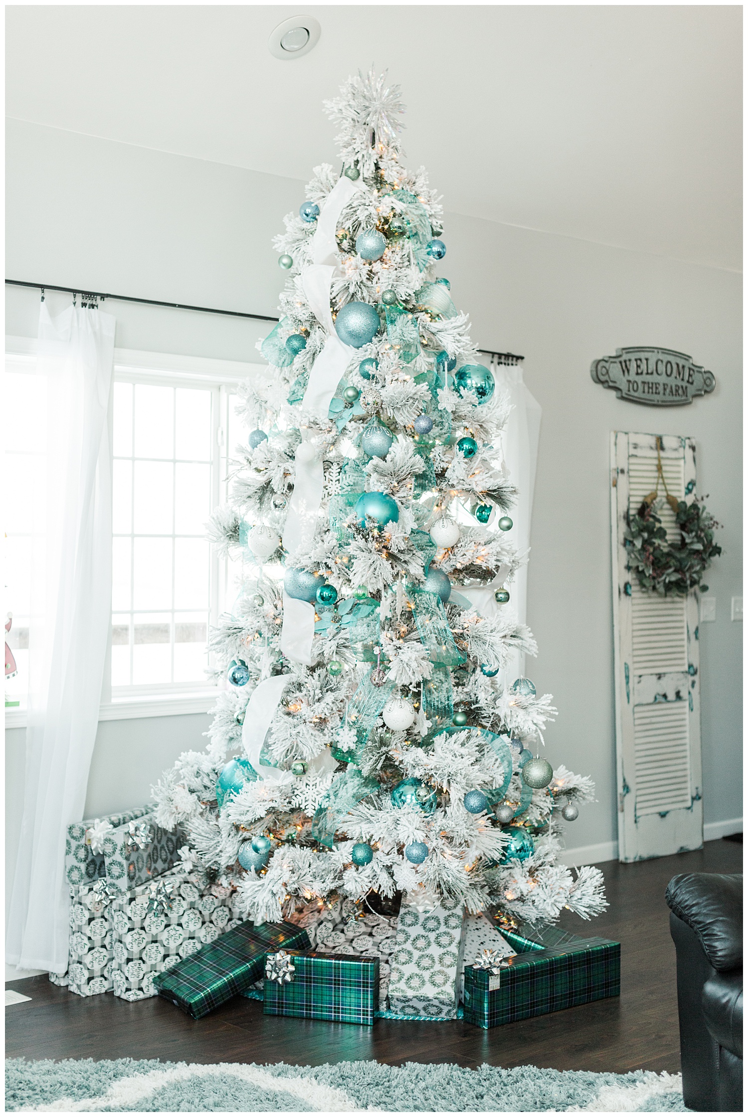 Flocked Christmas tree decorated with white and teal ribbon and teal, light blue and aqua ornaments | CB Studio