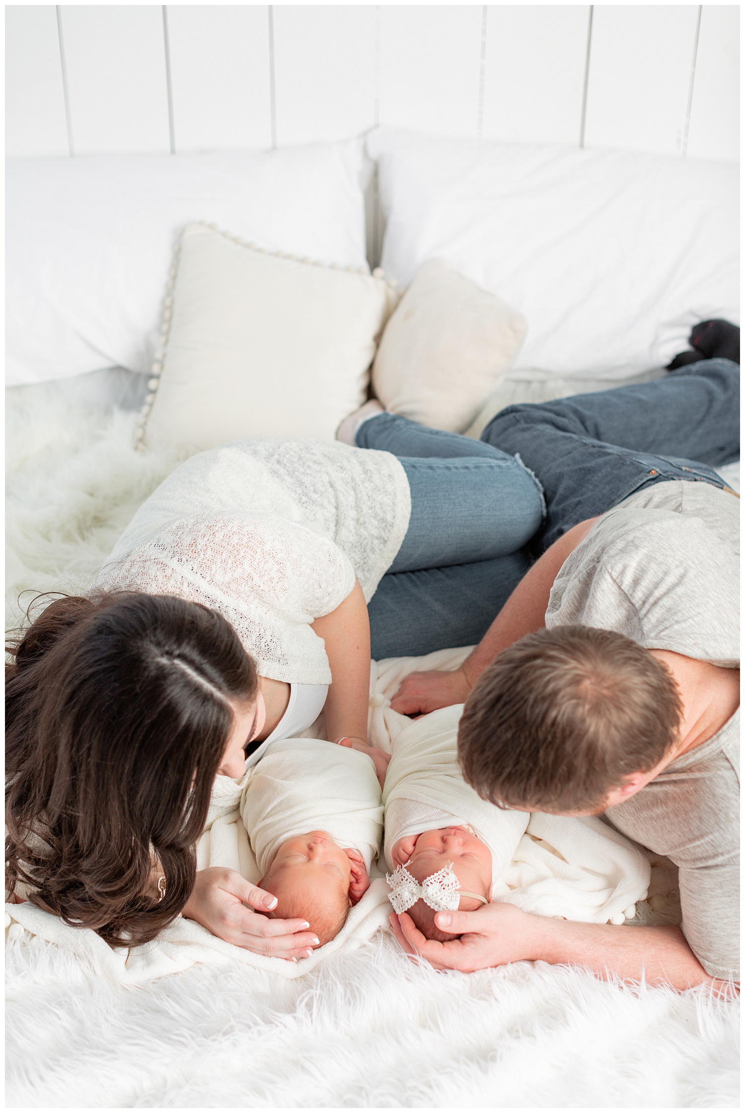 New mom and dad snuggle their newborn baby boy/girl twins | CB Studio