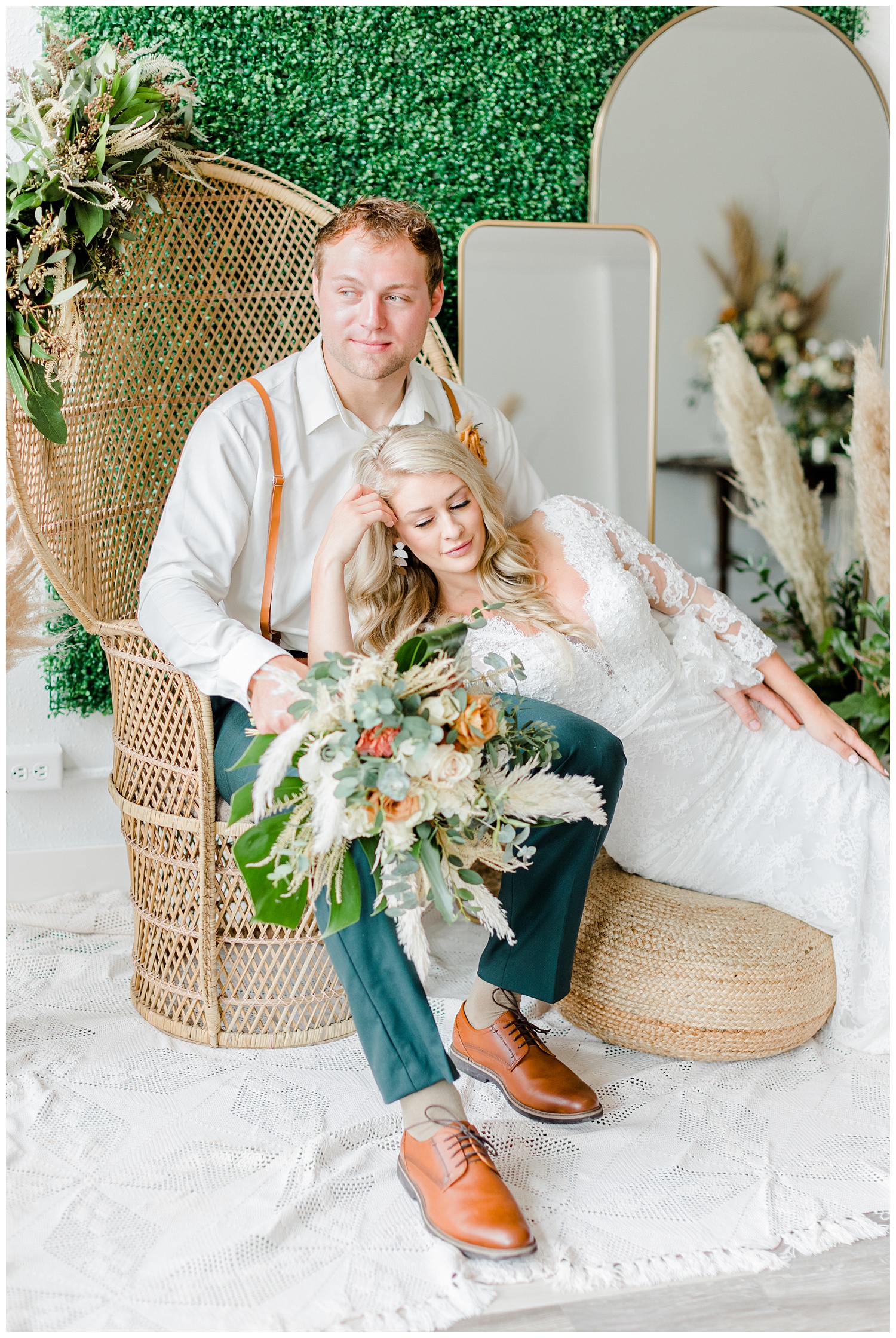 Boho groom sits in a vintage wicker peacock chair with his bride draped in his lap | CB Studio