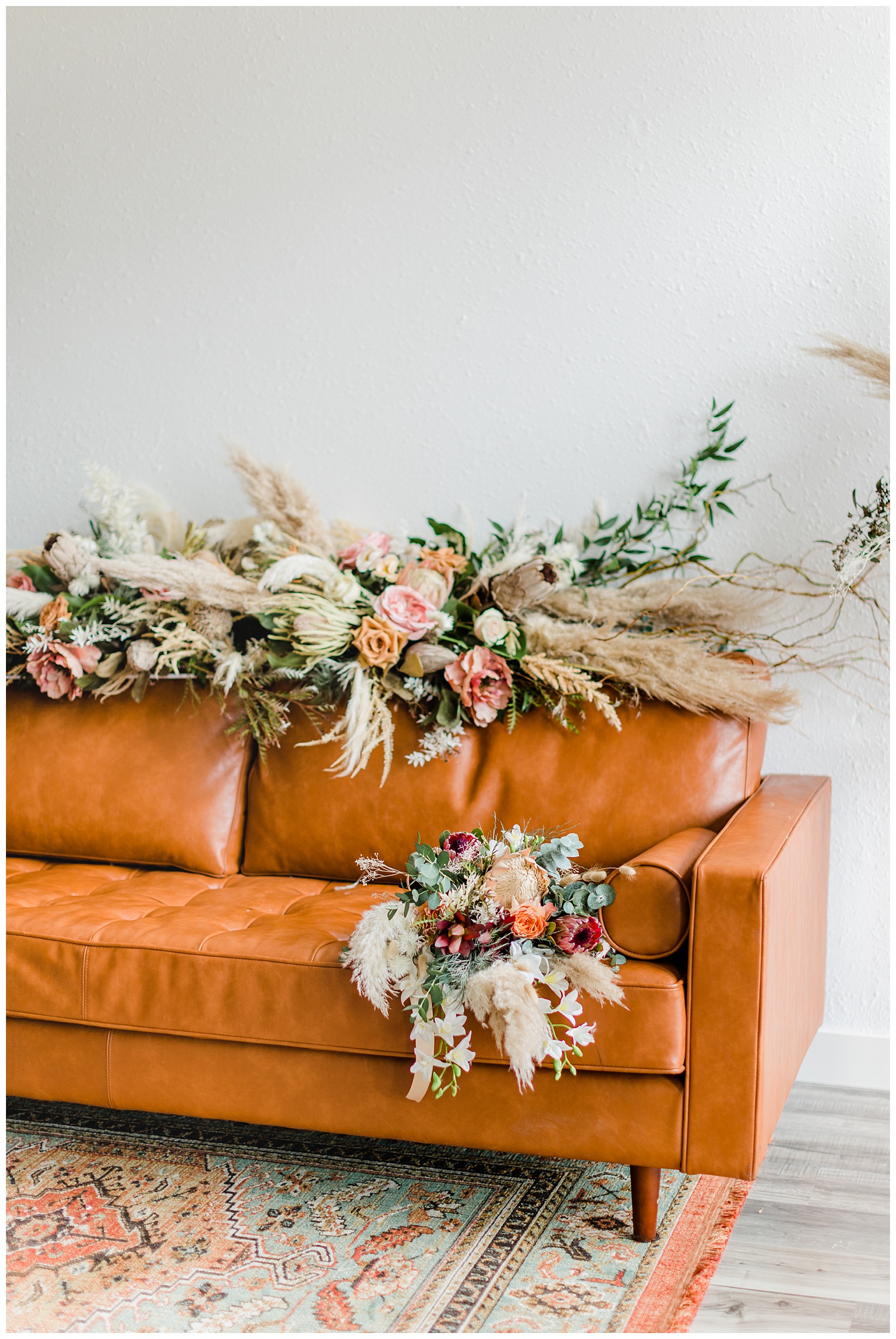 Vintage Boho floral couch arrangement and bridal bouquet complete with pampas grass, roses, eucalyptus and other dried florals | CB Studio