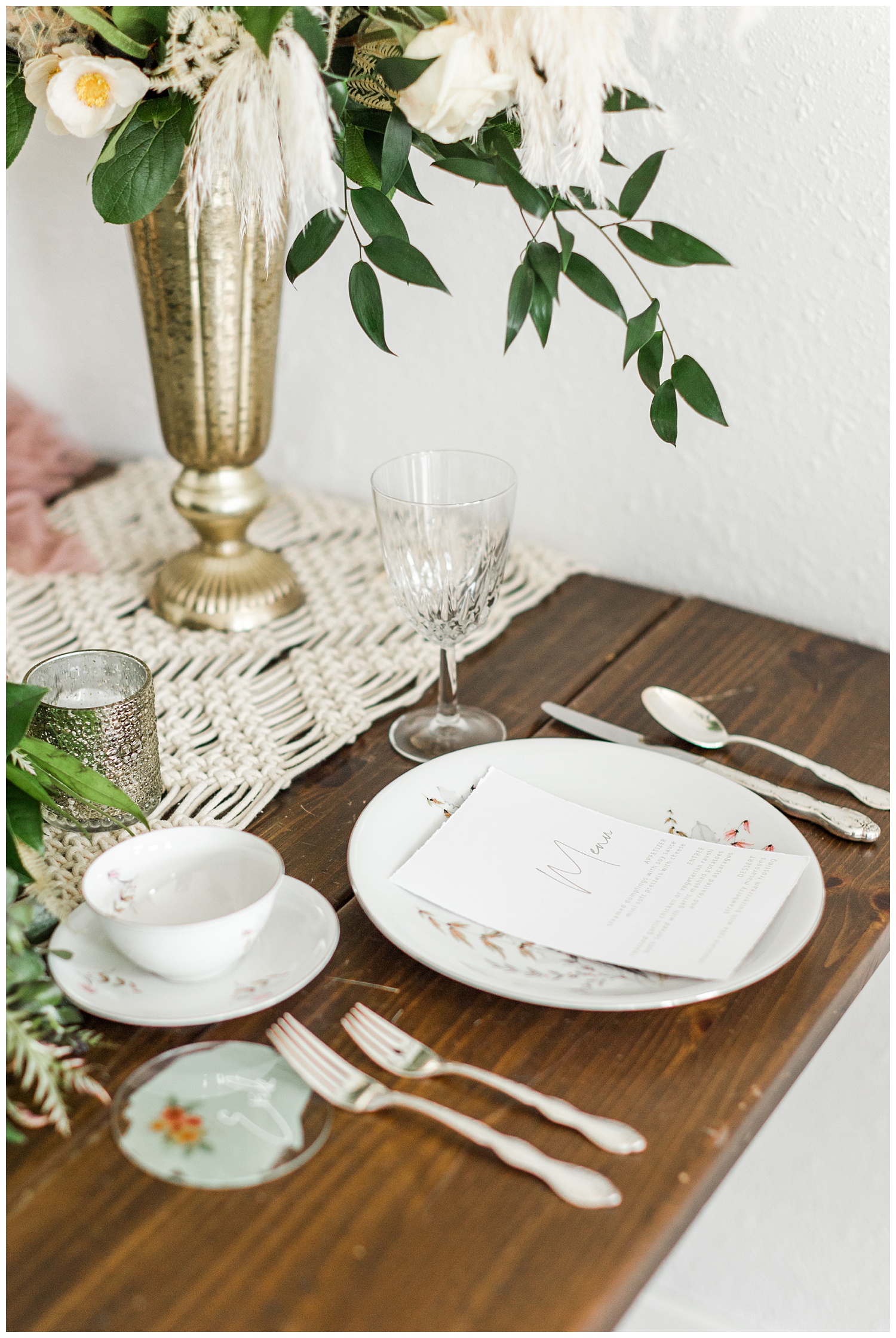 Vintage blush wedding place setting complete with boho florals, macrame and eucalyptus table runner and antique china | CB Studio