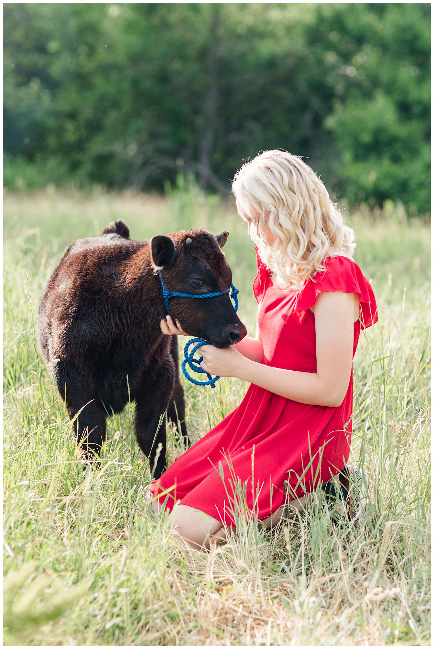 Senior girl Molly snuggles her baby calf in a grassy pasture | CB Studio