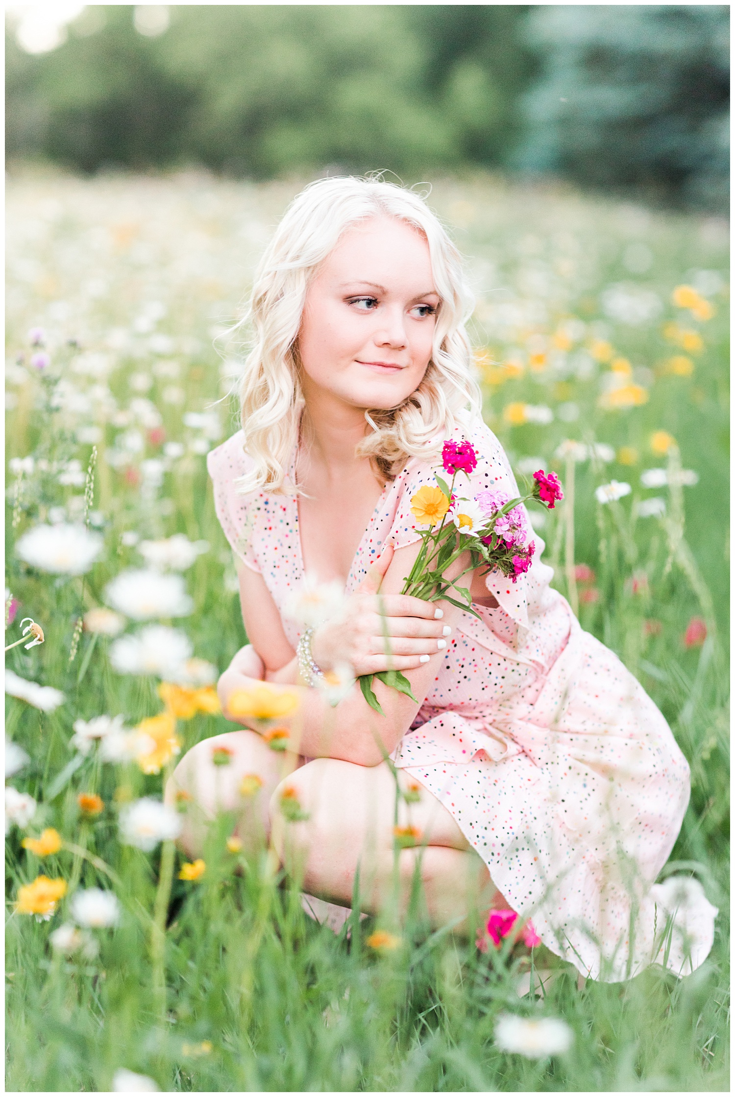 Senior girl Molly in a flower field holding a bouquet of wildflowers | CB Studio