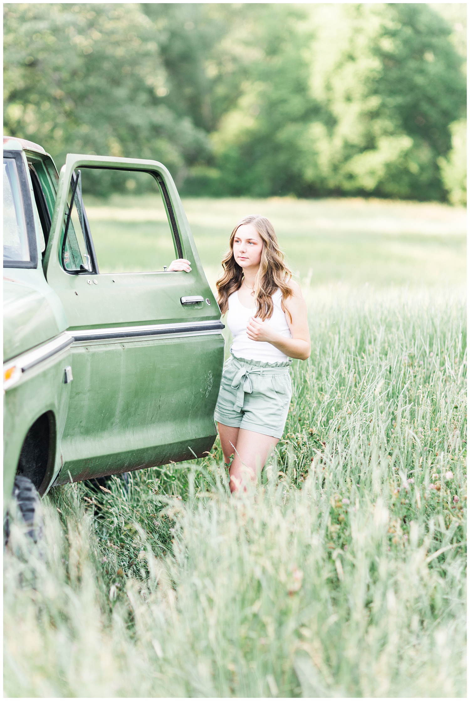 Senior Taylor standing next to an old green Ford truck in a grassy field | CB Studio