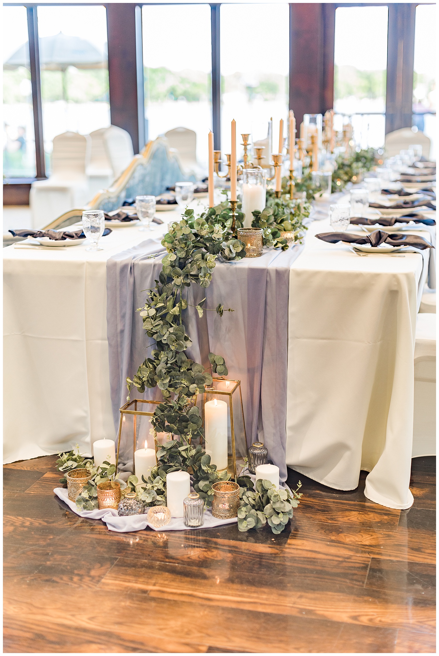 Dusty blue and peach kings wedding table topped with gold vintage candlesticks and eucalyptus with the decor draping to the floor at the Shores at Five Island | CB Studio