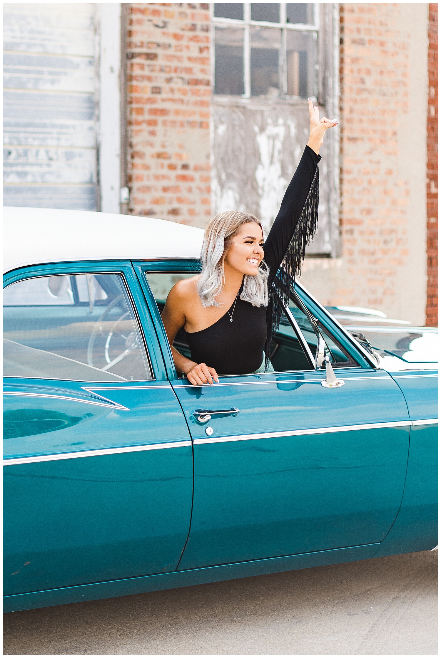 Addison throws a peace sign out of the window of a teal 1967 Chevy Bel Air | CB Studio