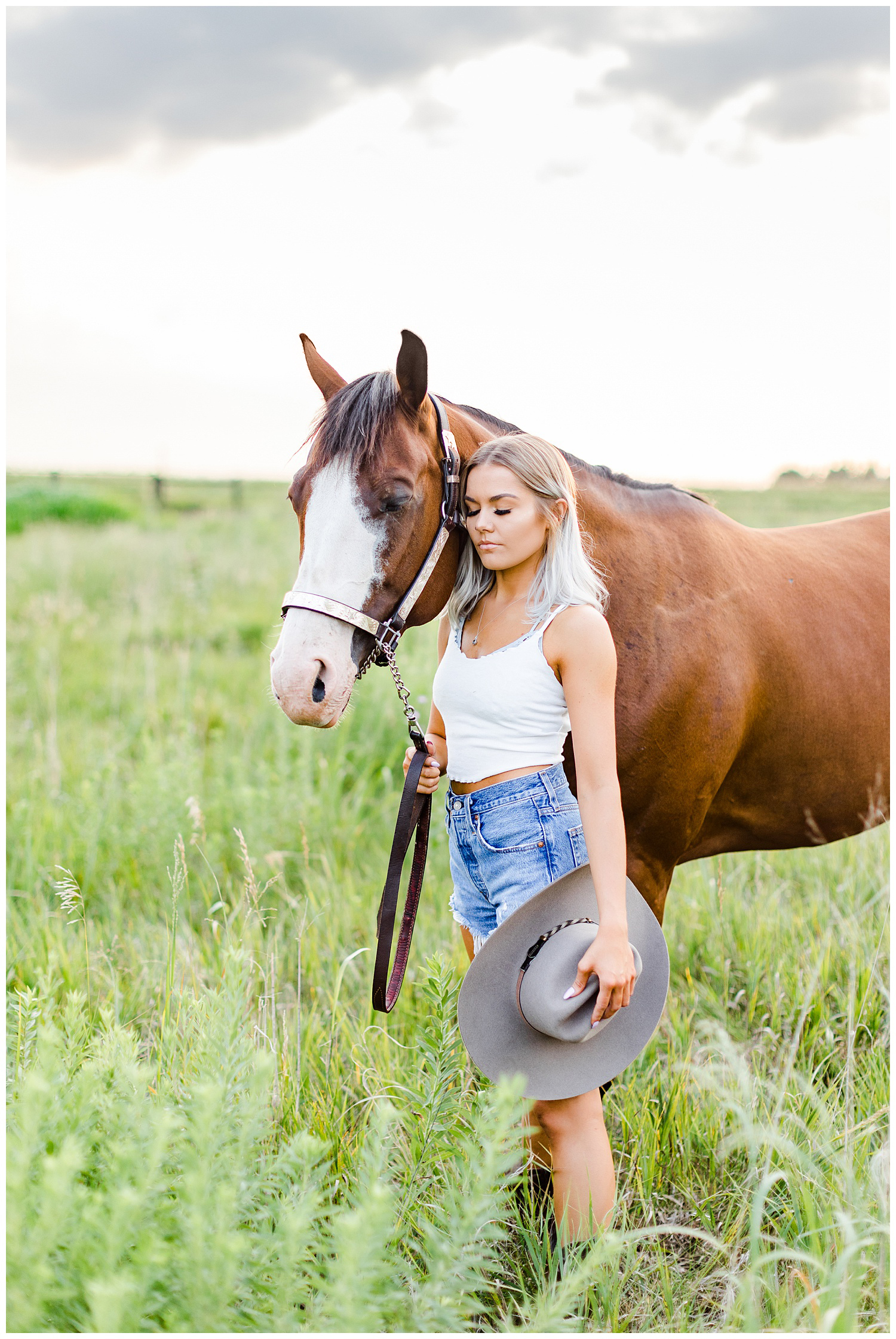 Addison snuggles Miss Flirty the horse in a grassy field | CB Studio