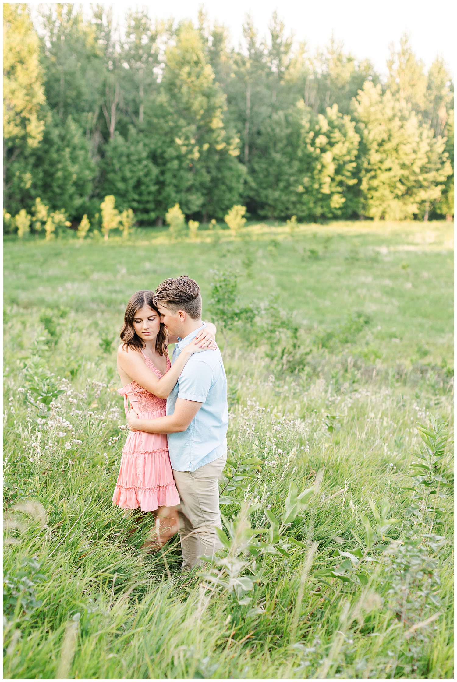 Jadi and Luke embrace each other in a beautiful grassy pasture with epic views | CB Studio