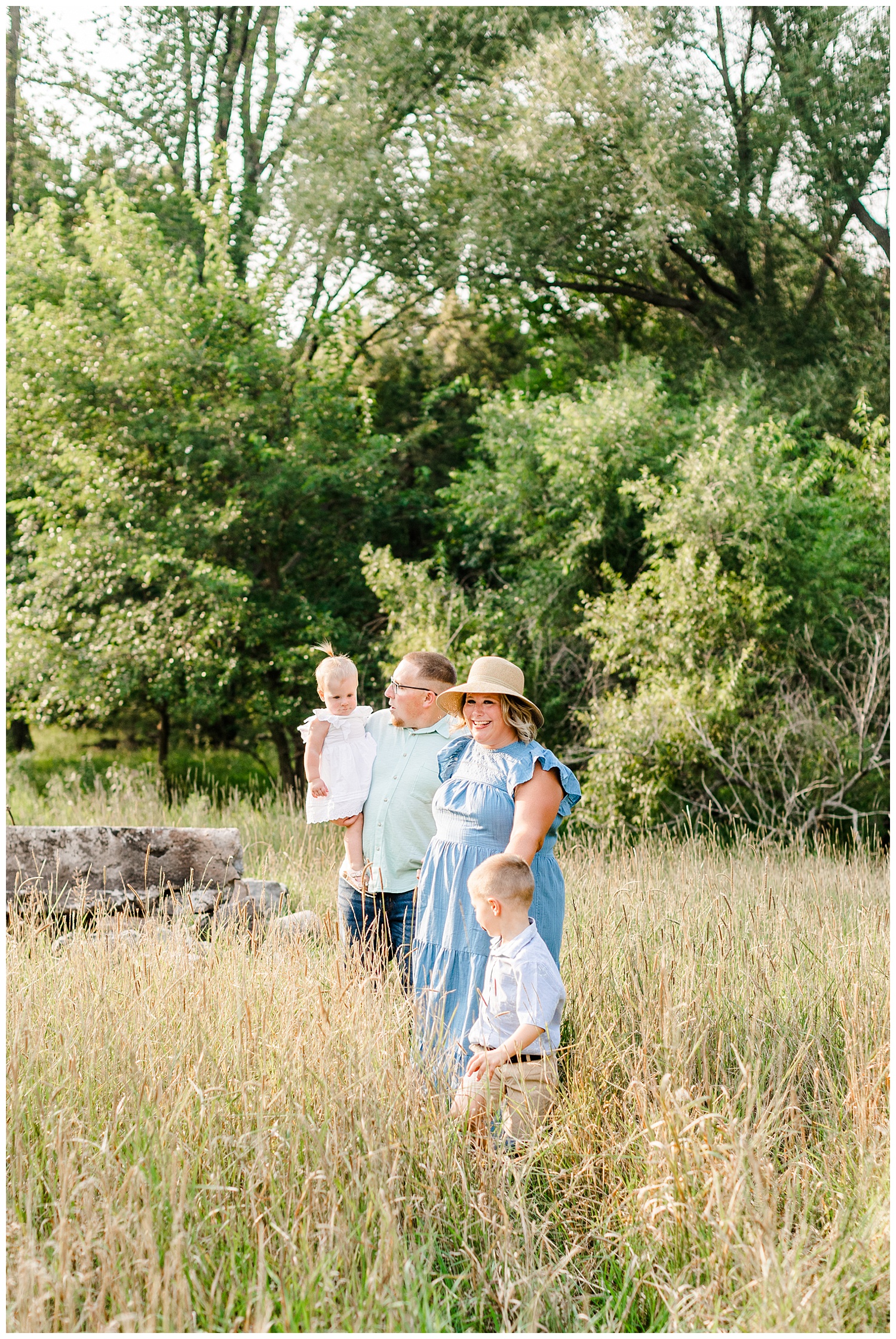 The Bruhn family walk together in a grassy pasture in Iowa | CB Studio