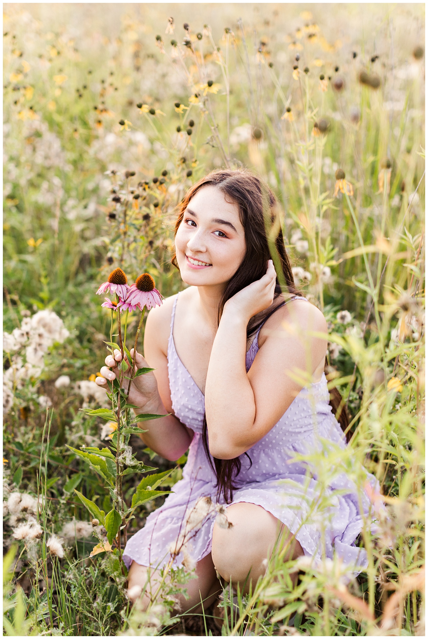 Laney, wearing a lilac dress, sits in a field of wildflowers | CB Studio
