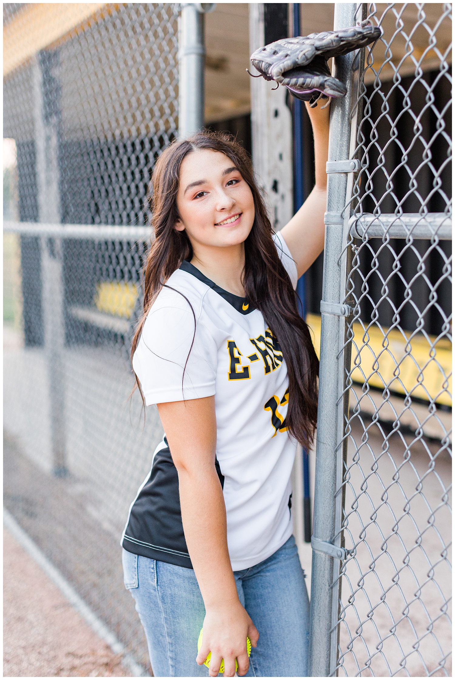 Laney, starting pitcher for the E-Hawks, leans against the softball field fence | CB Studio