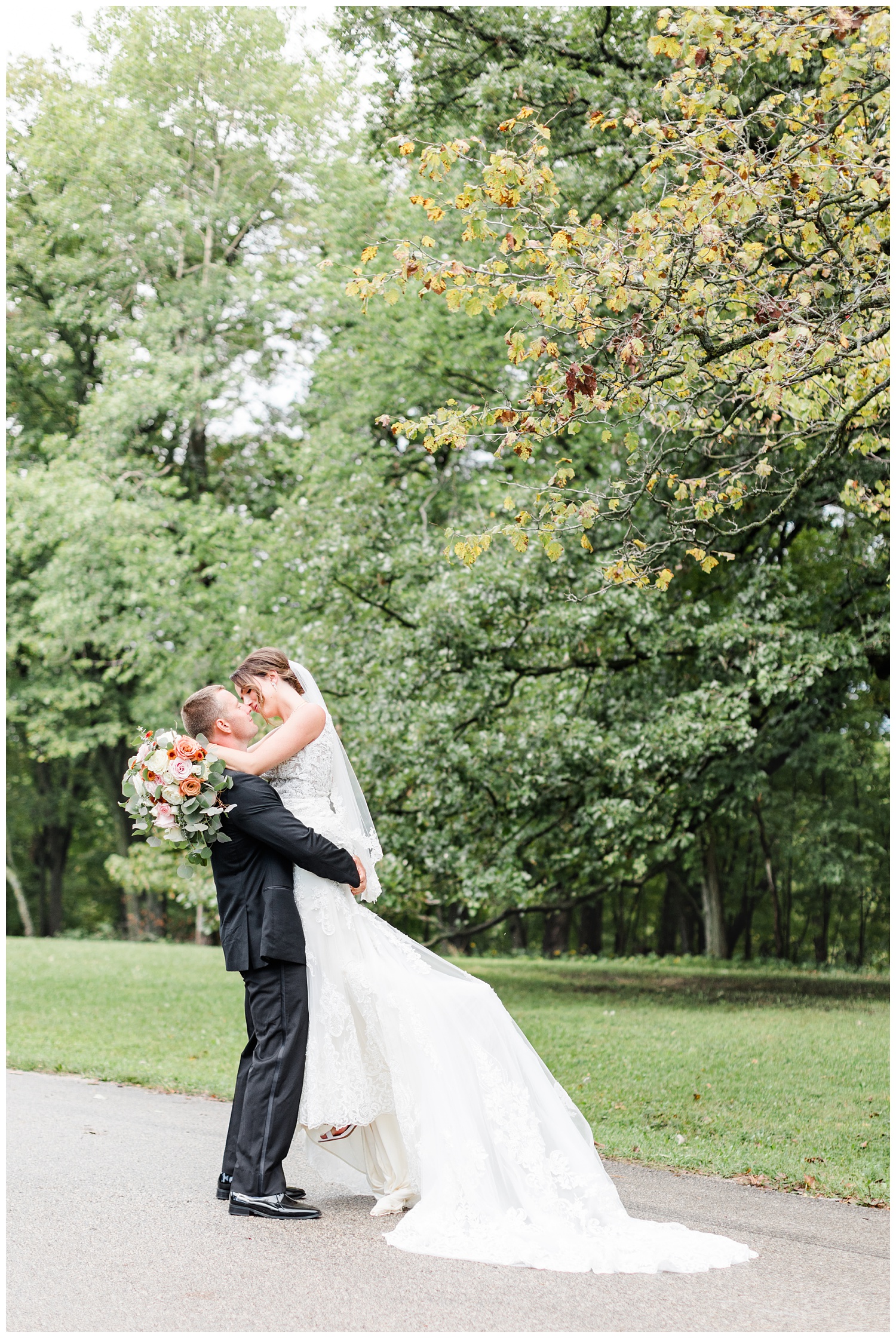 Cody lifts his bride up for a kiss along a path at Call State Park before their wedding ceremony | CB Studio