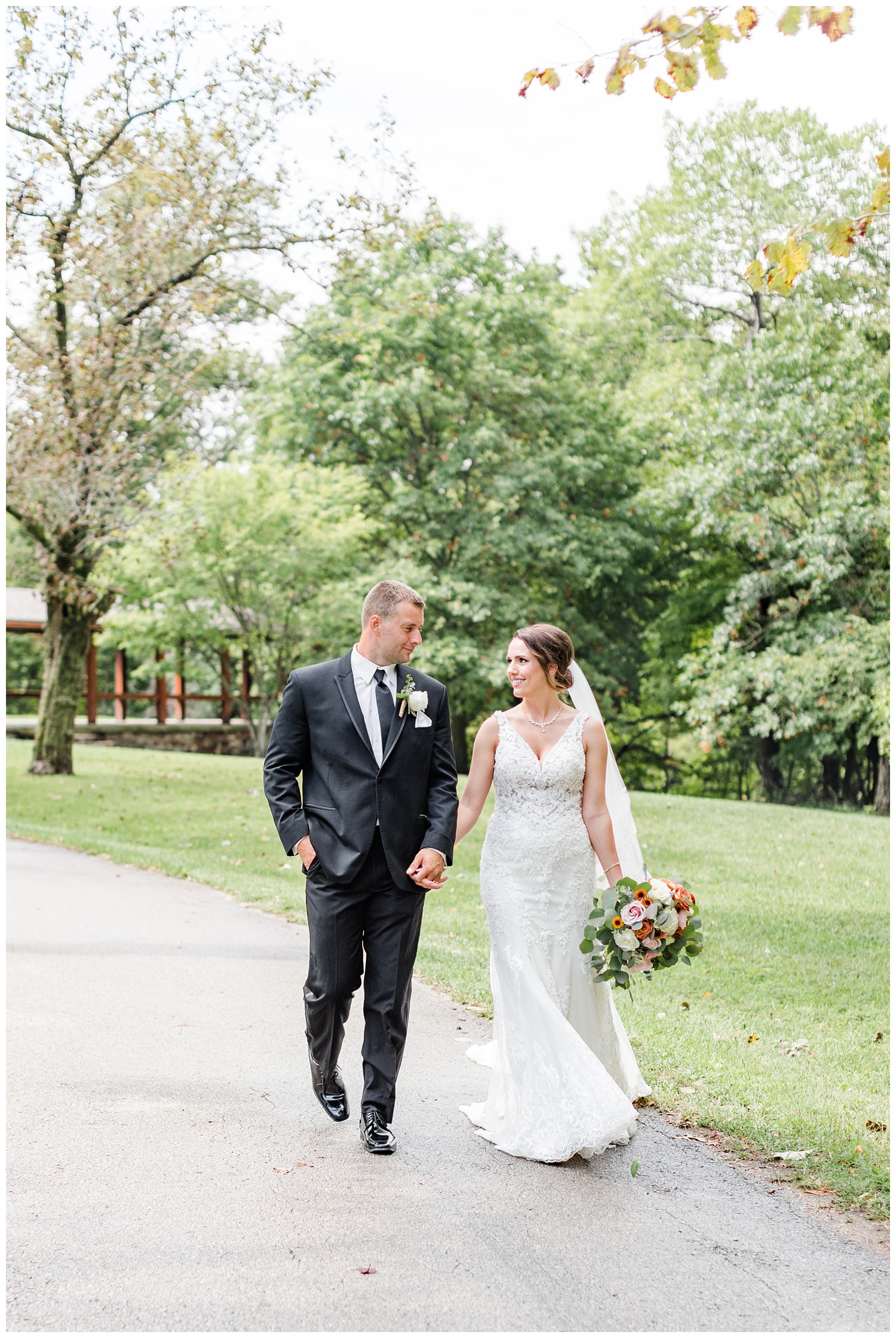 Bride and groom, Renee and Cody, walk along a path at Call State Park before their wedding ceremony | CB Studio