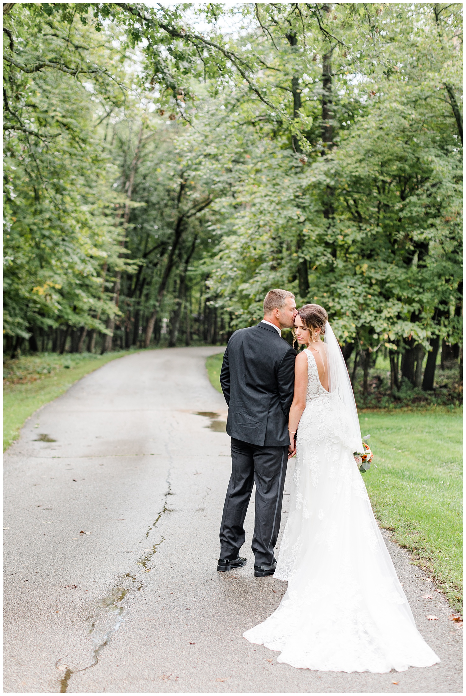 Bride and groom, Renee and Cody, stop for a kiss along a path at Call State Park before their wedding ceremony | CB Studio