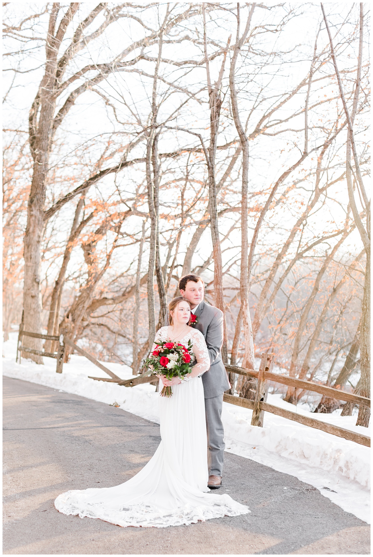 Bride and groom embrace on a snowy path at Reasoner Dam in Humboldt, IA | CB Studio