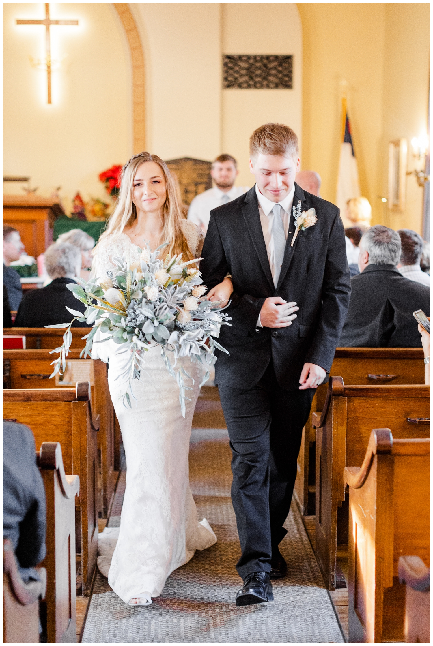 Bride and groom walk down the aisle following their wedding ceremony at The Little Brown Church in the Vale in Nashua, IA | CB Studio