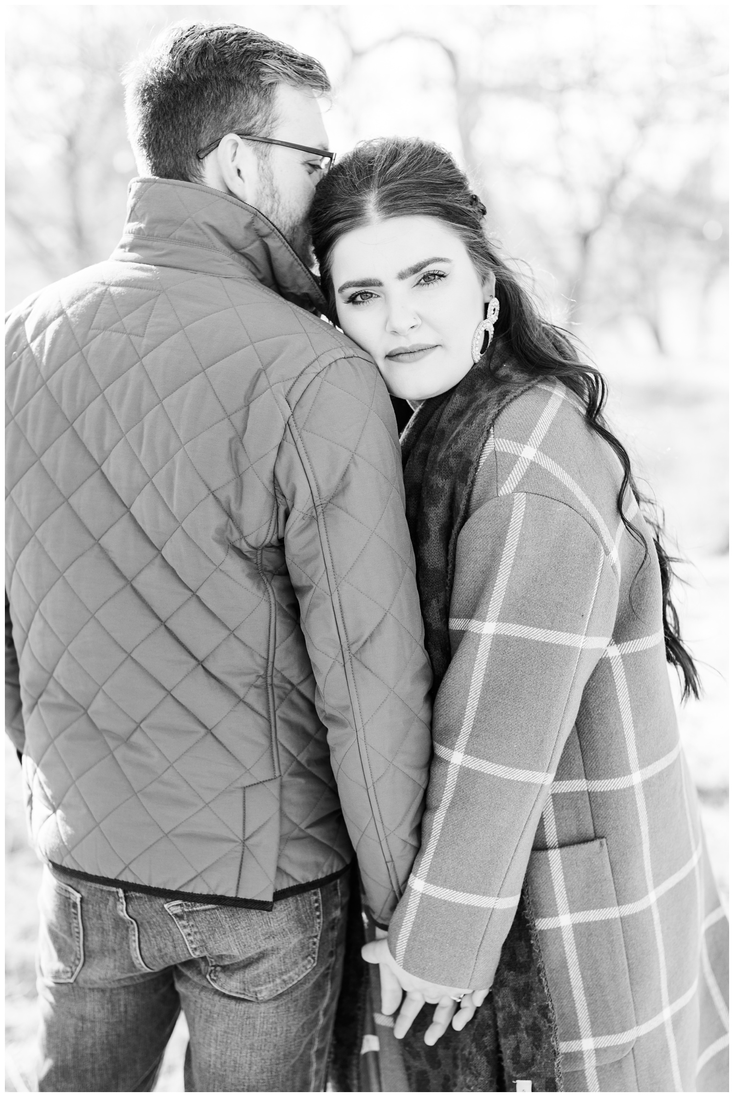 Rachel rests her head on her fiance's shoulder as they hold hands | CB Studio