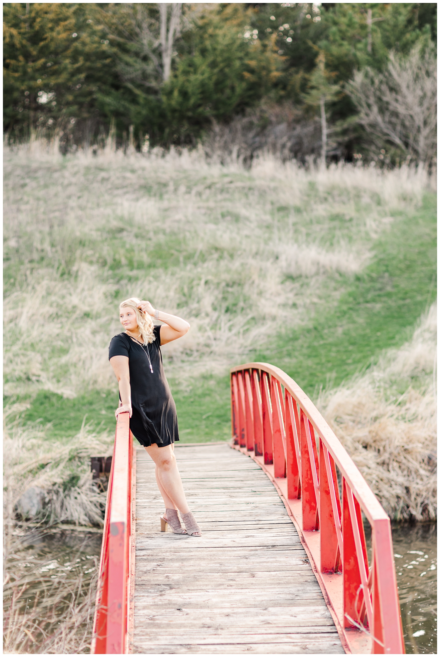 Abby leans against a red bridge at Water's Edge Nature Center in Algona, IA | CB Studio